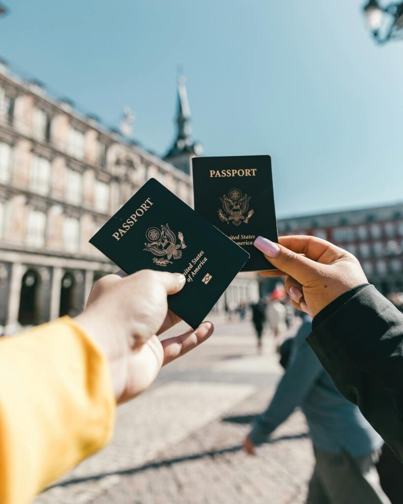 2 girls holding up their passports 