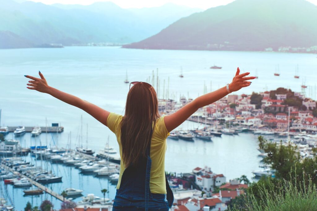 woman looking at a beautiful scenery while traveling 