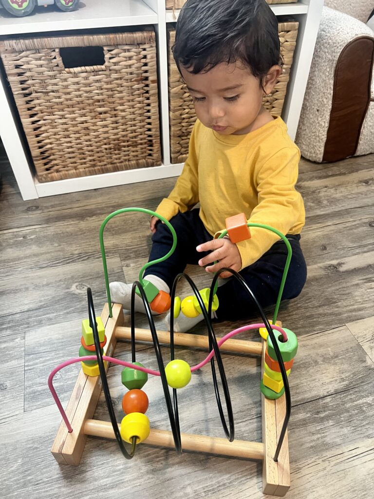 toddler engaging in maze toy 