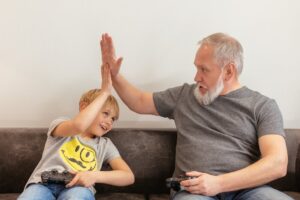 a young boy high-fiving his father.